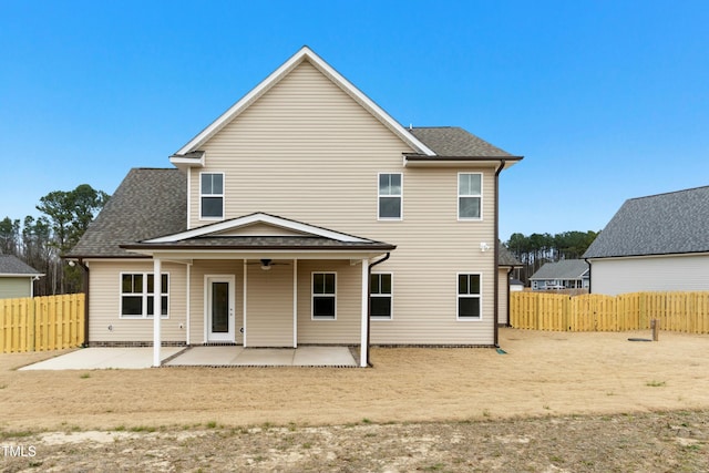 back of property with ceiling fan, a patio, a shingled roof, and fence