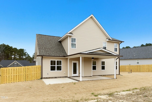 back of property with a patio, a shingled roof, a fenced backyard, and a ceiling fan