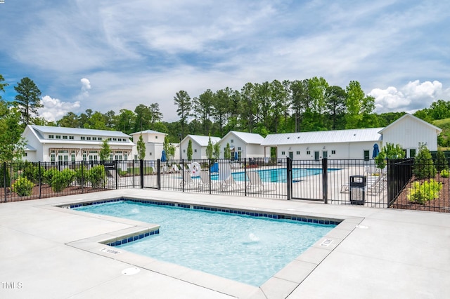 community pool featuring a patio area and fence