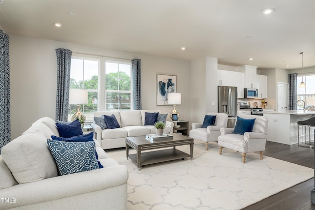living area featuring dark wood-style floors and recessed lighting