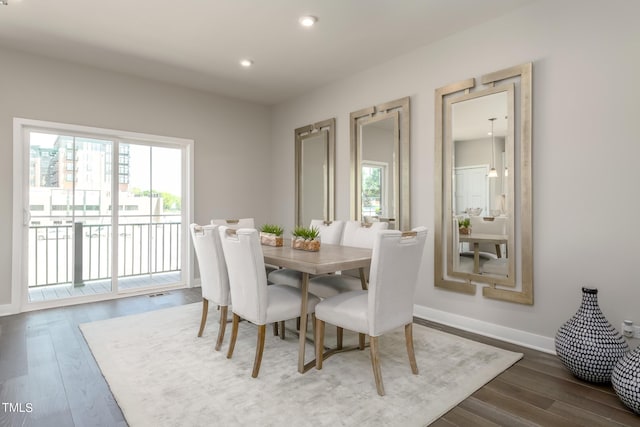 dining space with recessed lighting, dark wood finished floors, and baseboards