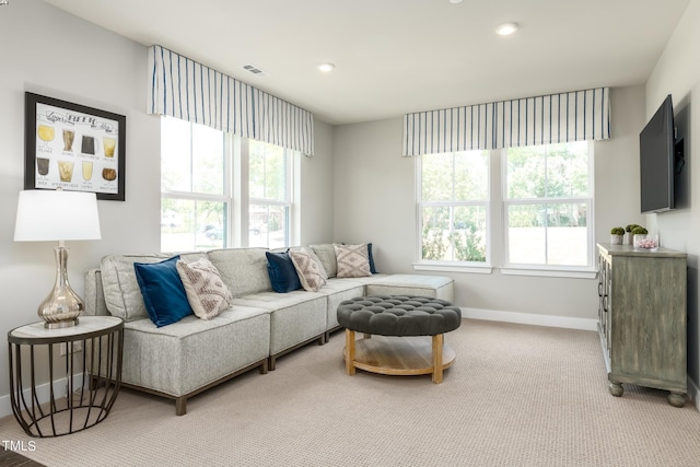 carpeted living area with baseboards, visible vents, and recessed lighting