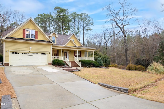 craftsman-style house with covered porch, concrete driveway, and a front yard