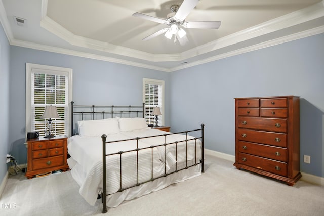 bedroom with baseboards, visible vents, a raised ceiling, and light colored carpet