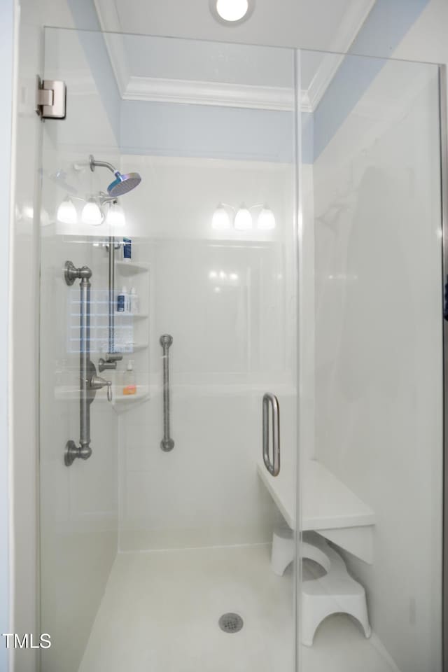 full bathroom featuring ornamental molding and a stall shower