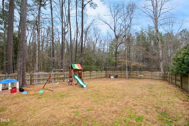 view of yard featuring a playground and a fenced backyard