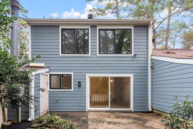 back of house with a patio