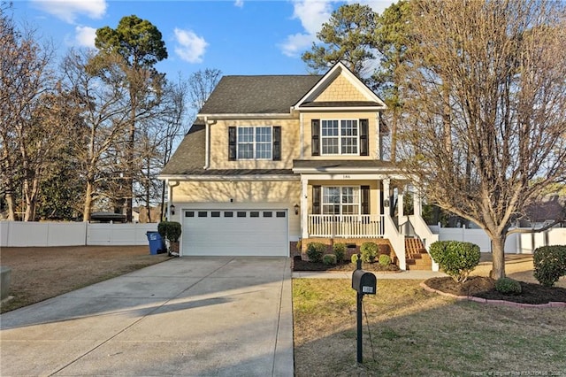 view of front of property featuring a garage, covered porch, fence, and concrete driveway