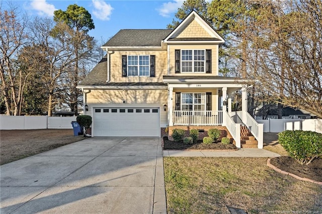 view of front of home featuring driveway, covered porch, a garage, and fence