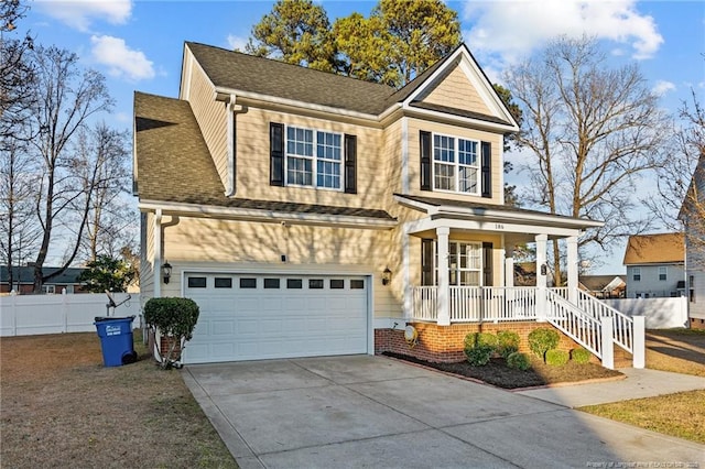 traditional-style house featuring a porch, an attached garage, fence, driveway, and roof with shingles