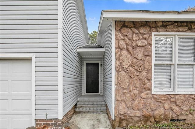 doorway to property with a garage