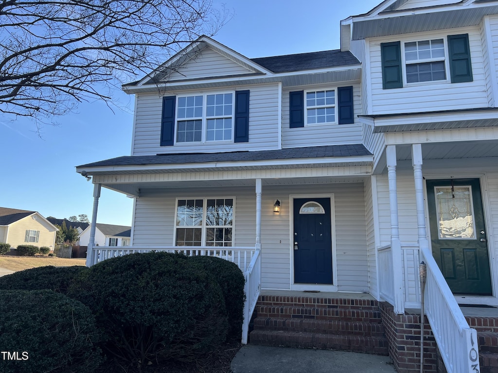 view of front of property with a porch and roof with shingles