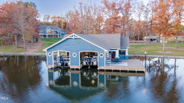 view of dock featuring a lawn and a water view