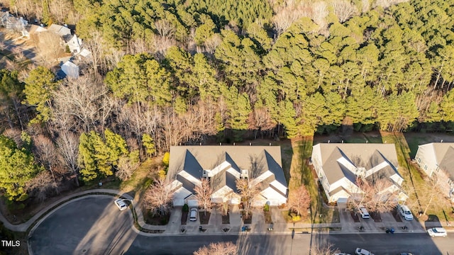 bird's eye view with a wooded view