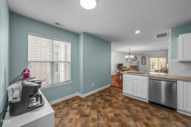 kitchen featuring white cabinets, visible vents, dishwasher, and a sink