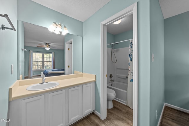 full bath with toilet, wood finished floors, shower / bath combo with shower curtain, a textured ceiling, and vanity