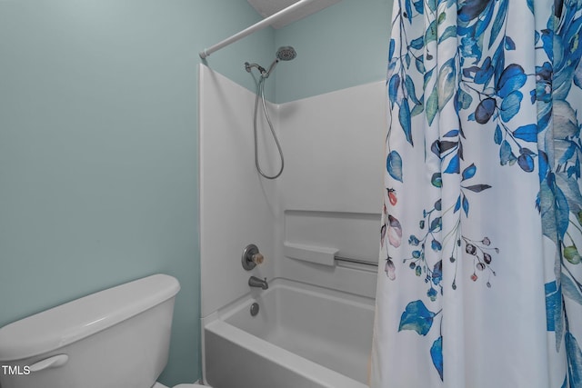 bathroom with shower / bath combo with shower curtain and toilet