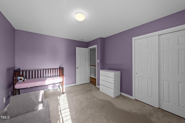 unfurnished bedroom with a closet, carpet, and baseboards