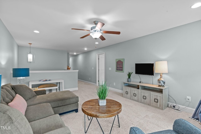 living room with light carpet, ceiling fan, baseboards, and recessed lighting