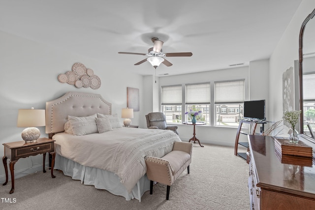 carpeted bedroom featuring baseboards and ceiling fan