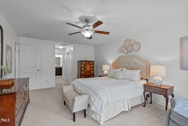 bedroom featuring light carpet, baseboards, connected bathroom, and ceiling fan