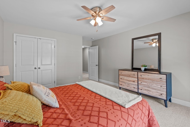 bedroom with baseboards, carpet flooring, a closet, and a ceiling fan