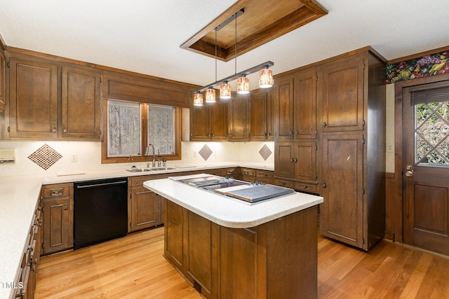 kitchen featuring a sink, light wood-style floors, light countertops, and dishwasher