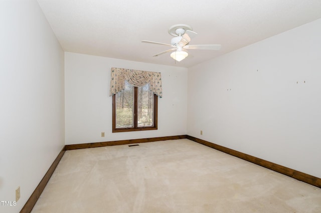 unfurnished room featuring light carpet, ceiling fan, visible vents, and baseboards