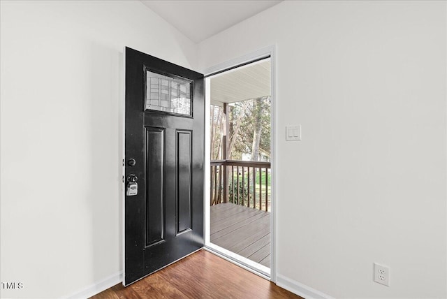 foyer with baseboards and wood finished floors