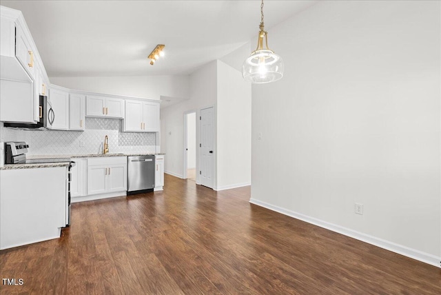 kitchen featuring tasteful backsplash, white cabinets, lofted ceiling, dark wood-style flooring, and stainless steel appliances