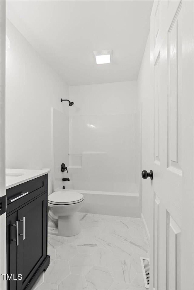 bathroom featuring toilet, bathing tub / shower combination, vanity, visible vents, and marble finish floor