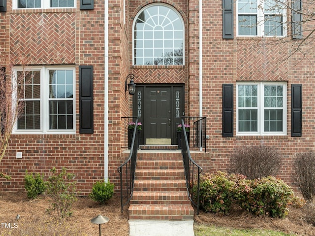 view of exterior entry with brick siding