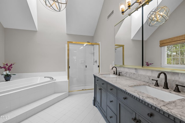 bathroom featuring a bath, visible vents, a stall shower, and a sink