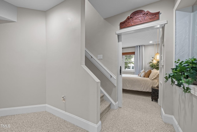 stairs with baseboards and carpet