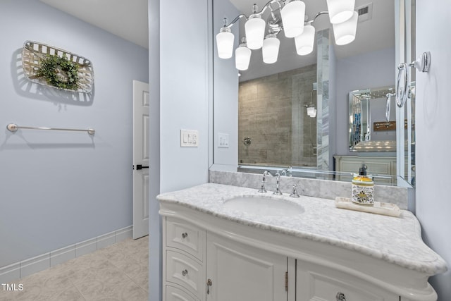 bathroom with visible vents, baseboards, tiled shower, tile patterned floors, and vanity