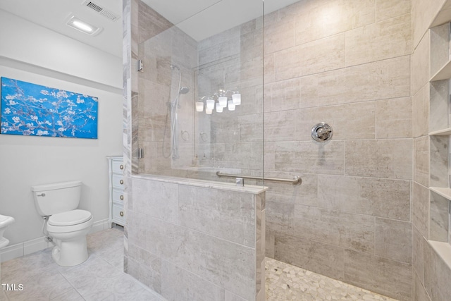 bathroom with toilet, baseboards, visible vents, and walk in shower