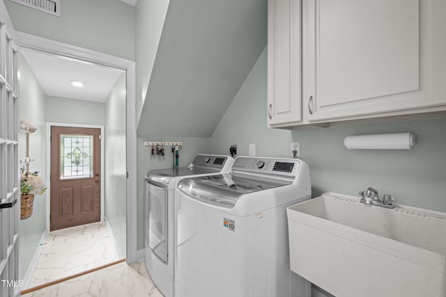 clothes washing area with visible vents, washing machine and clothes dryer, cabinet space, a sink, and marble finish floor