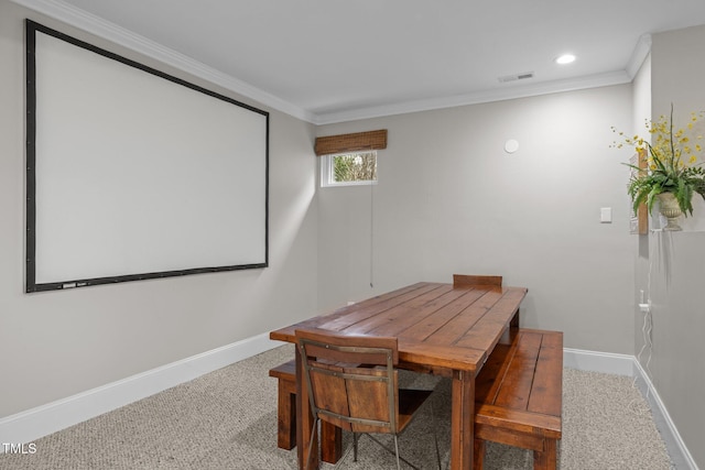 dining space featuring visible vents, baseboards, carpet, and crown molding