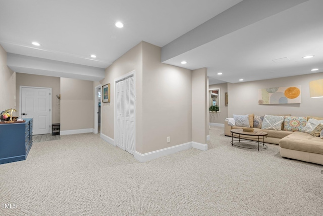 carpeted living area featuring recessed lighting and baseboards