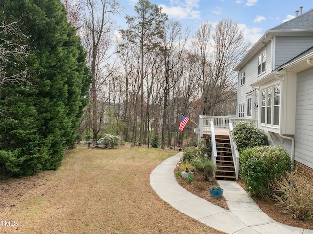 view of yard featuring stairs and a wooden deck