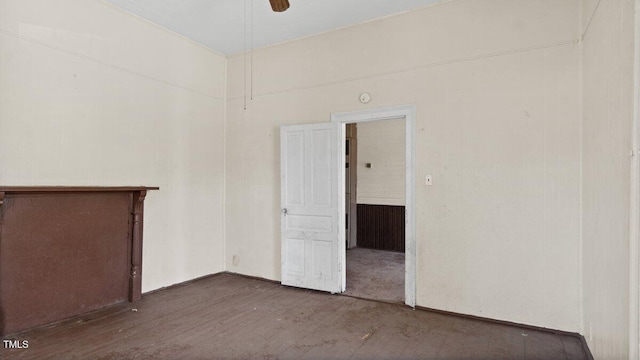 empty room with ceiling fan and wood finished floors