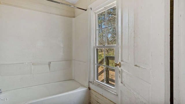 bathroom featuring a shower and a tub to relax in