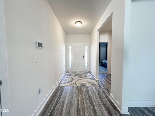 entrance foyer with visible vents, baseboards, and wood finished floors