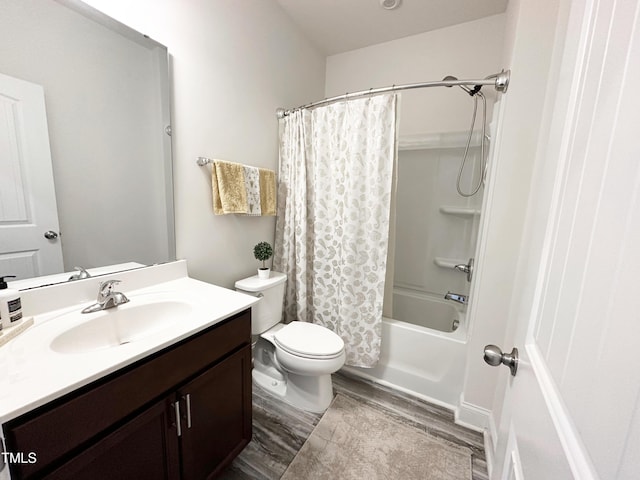 bathroom featuring toilet, wood finished floors, vanity, and shower / tub combo with curtain