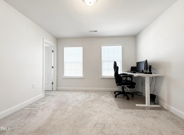 office space featuring carpet flooring, visible vents, and baseboards