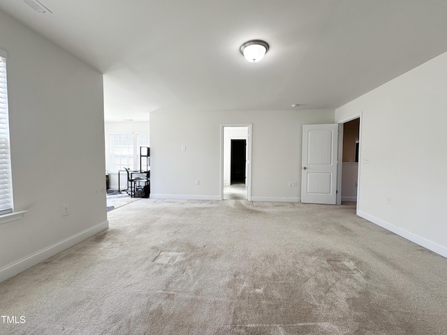 carpeted spare room with baseboards