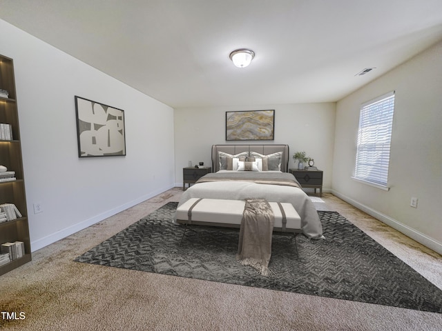 carpeted bedroom with visible vents and baseboards