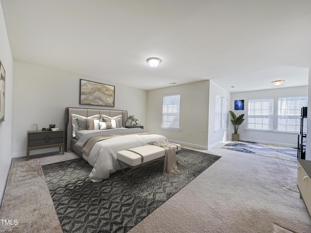 carpeted bedroom with baseboards