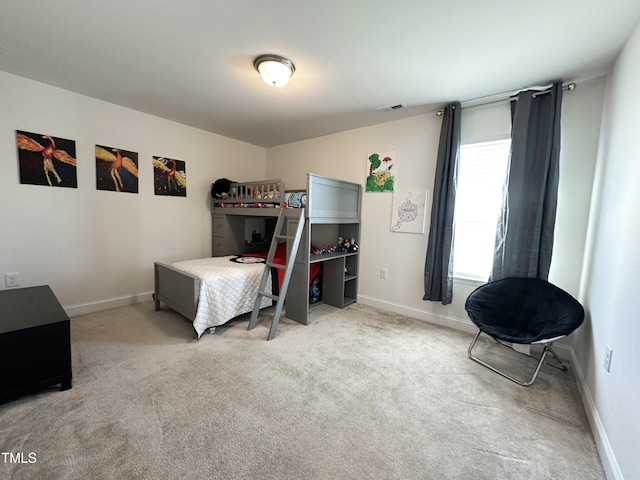 carpeted bedroom featuring baseboards and visible vents