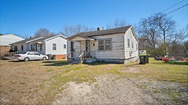 bungalow-style house with crawl space and a front yard